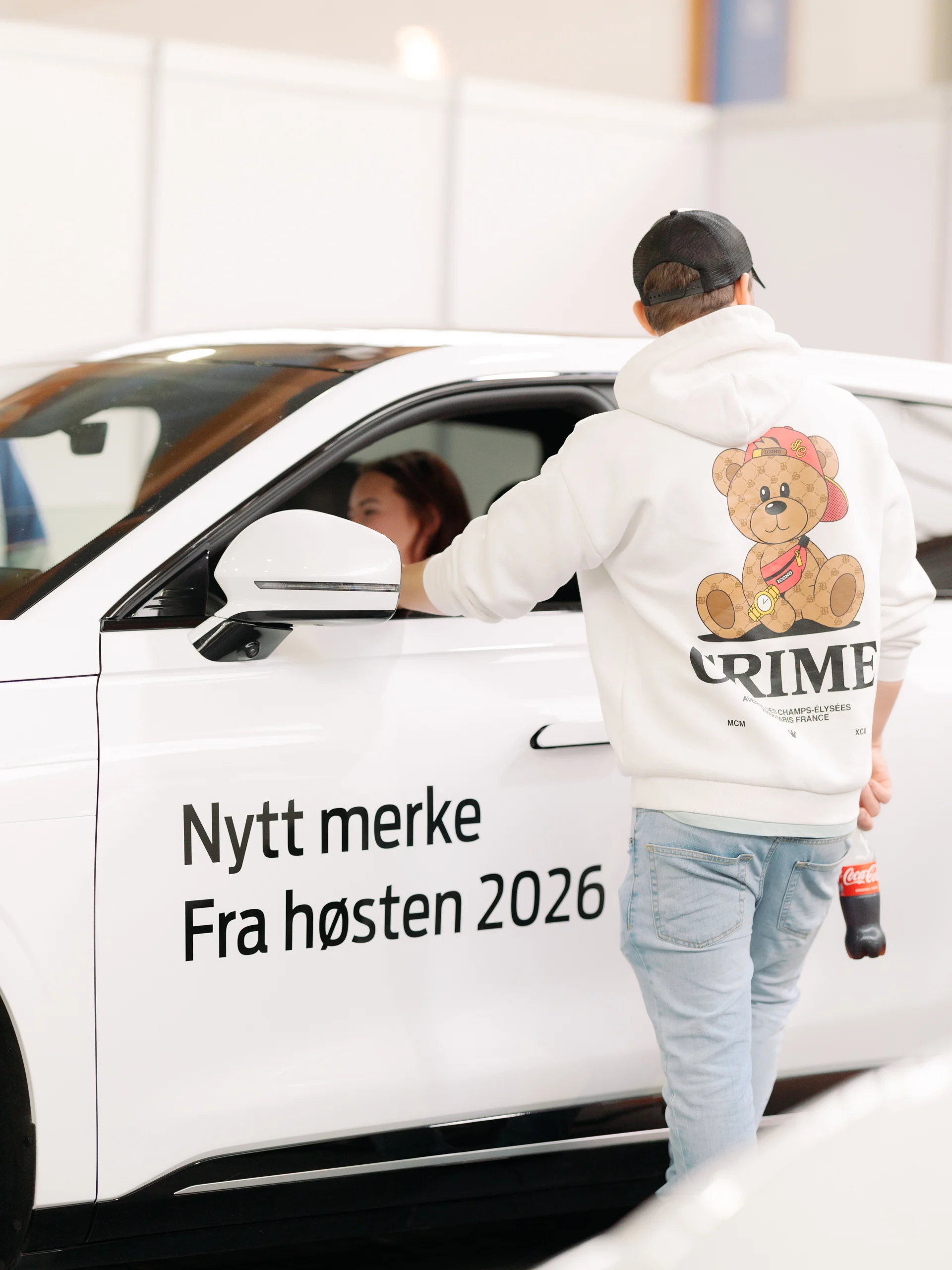 En besøkende lener seg inn vinduet på Exlantix ET og snakker med noen inni bilen